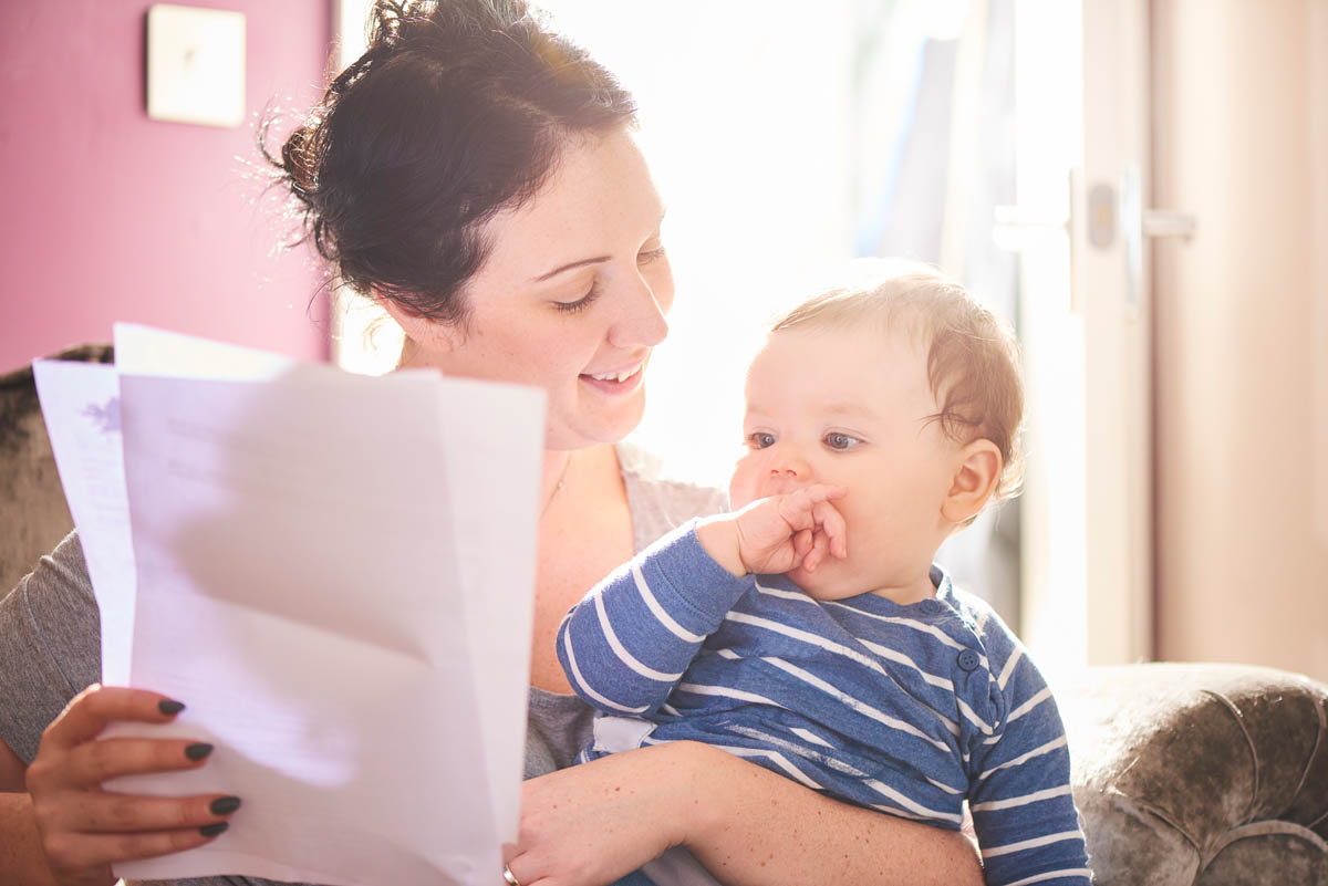 young mother reads through mortgage agreement